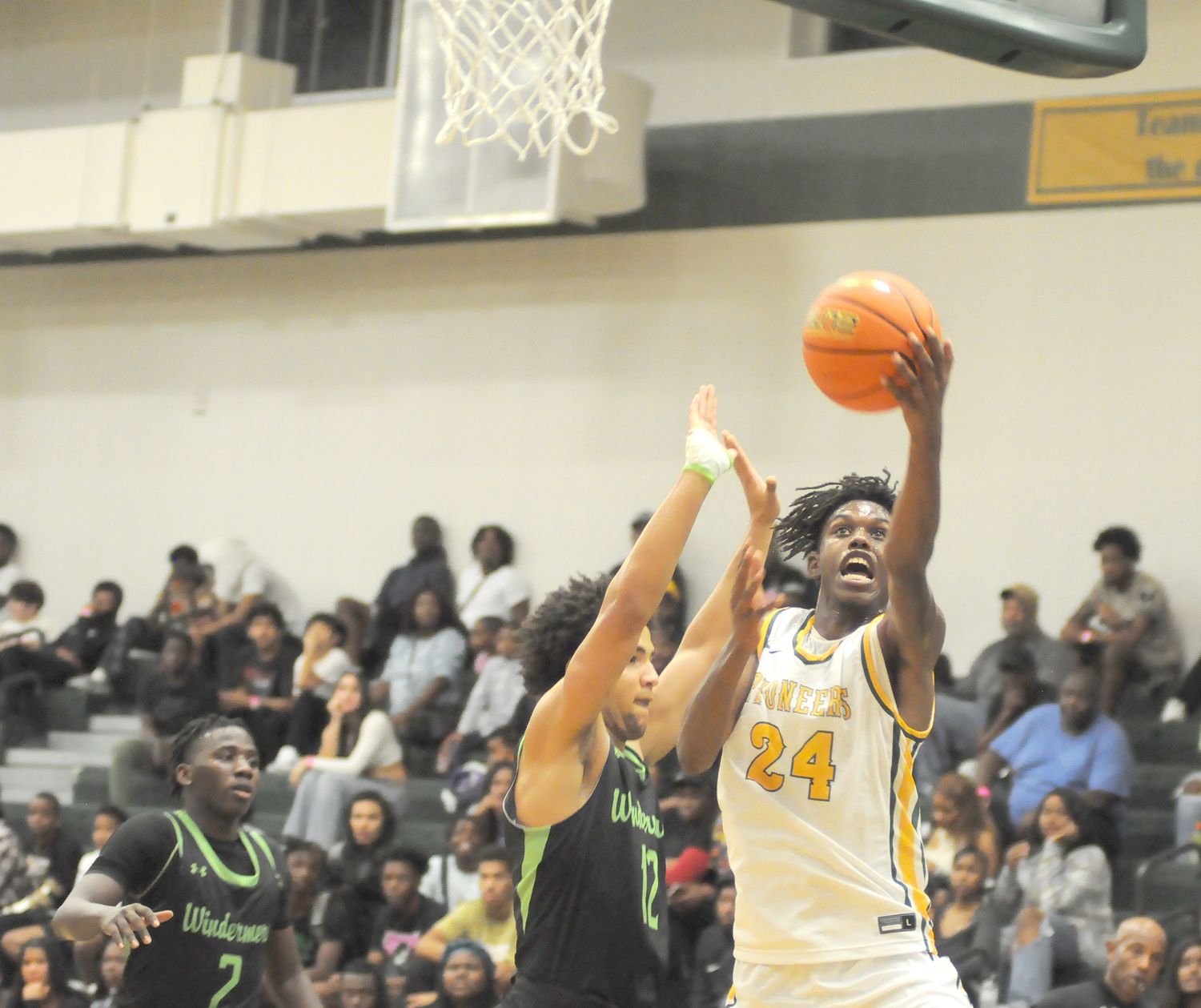 Oak Ridge's Tyler Davis (24) goes for a layup against Windermere's Cole White (12) as Isaiah Dorceus (2) prepares for a rebound during the fourth quarter of Oak Ridge's 62-56 victory in the Breast Cancer Awareness Classic. Davis had six points - all in the second half.